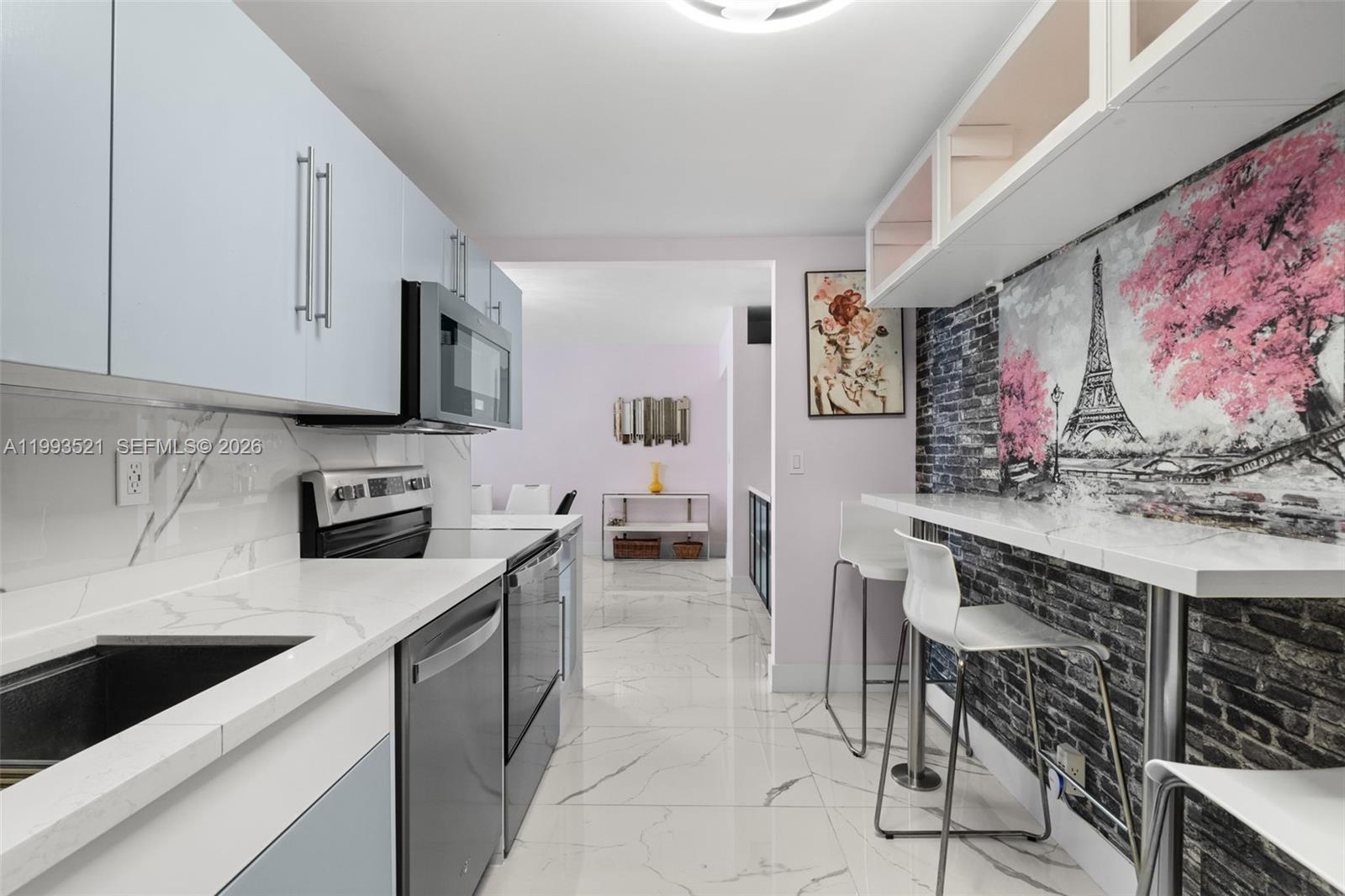 A living and dining area features white marble floors, a glass table, and white sofas — 3000 S Ocean Dr # 606, Hollywood FL 33019, HOLLYWOOD, FL