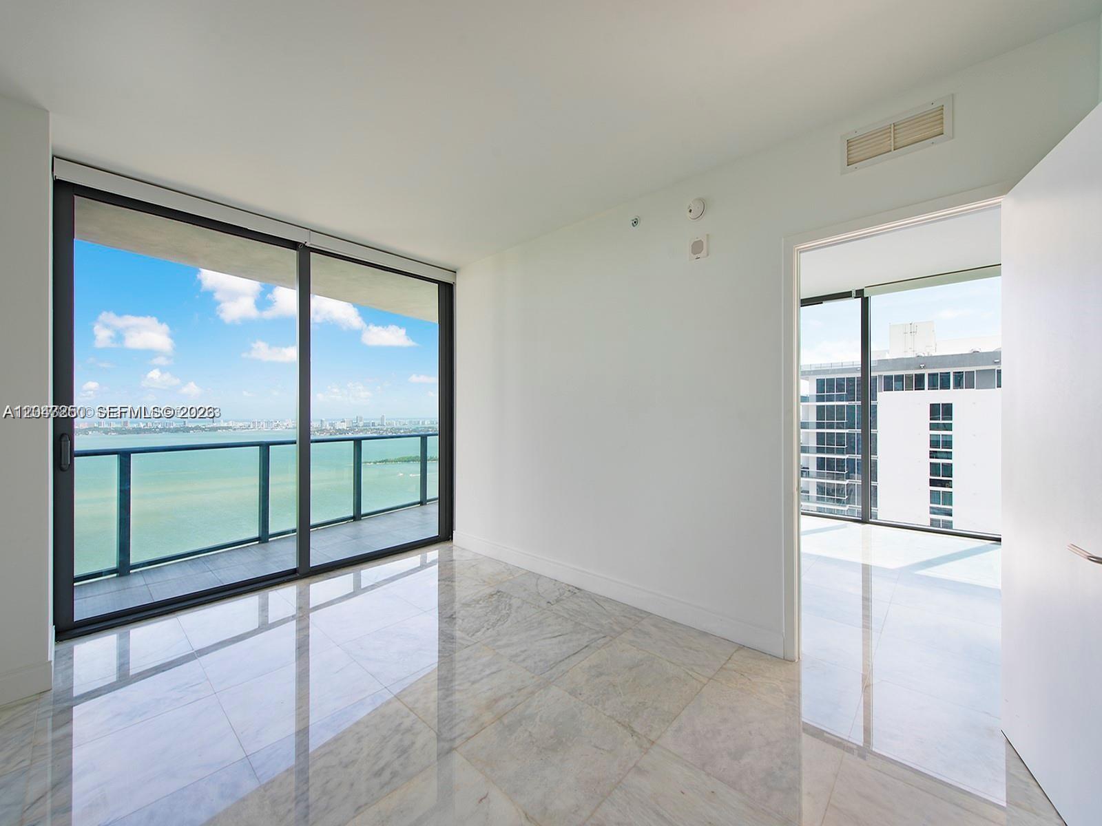 A bright room features marble floors, floor-to-ceiling windows, and a balcony overlooking the water — 460 NE 28th St # 3608, Miami FL 33137, MIAMI, FL