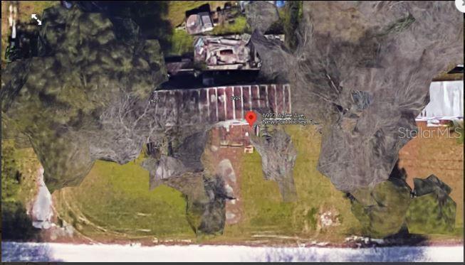 This is an aerial satellite view of a residential property with a house and yard — 6927 AZLEE AVENUE, NEW PORT RICHEY, FL