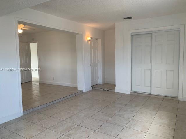 An interior view shows a tiled room with a doorway leading to another space — 4930 NW 13th St, Lauderhill FL 33313, LAUDERHILL, FL