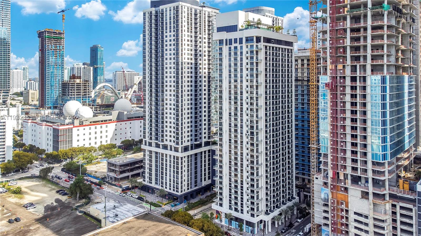 An aerial view shows several high-rise residential buildings and construction sites in an urban area — 11 NE 6 Street # 2201, Miami FL 33132, MIAMI, FL