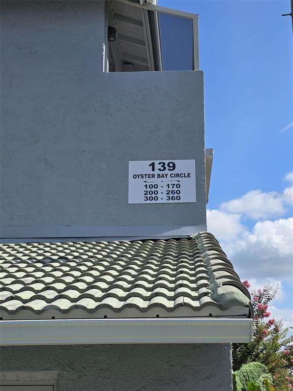 The exterior of a building shows a sign indicating unit numbers for Oyster Bay Circle — 139 OYSTER BAY CIRCLE UNIT 220, ALTAMONTE SPRINGS, FL