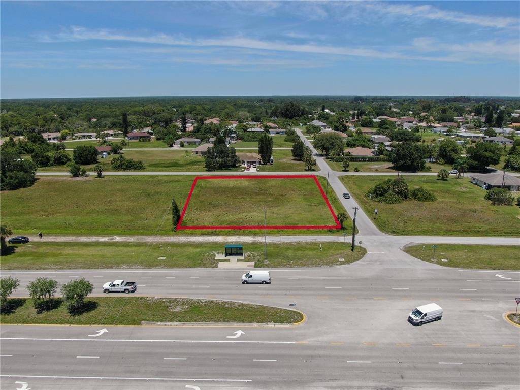 An aerial view shows a rectangular vacant lot outlined in red next to a paved road — 11996 TAMIAMI TRAIL S, NORTH PORT, FL