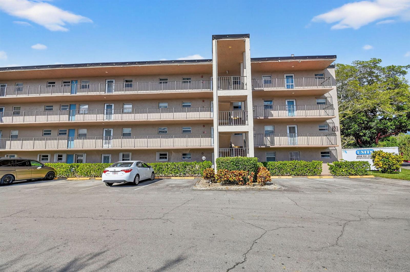 A three-story apartment building with exterior balconies and a parking lot in front — 729 Lori Drive # 302, Palm Springs FL 33461, PALM SPRINGS, FL