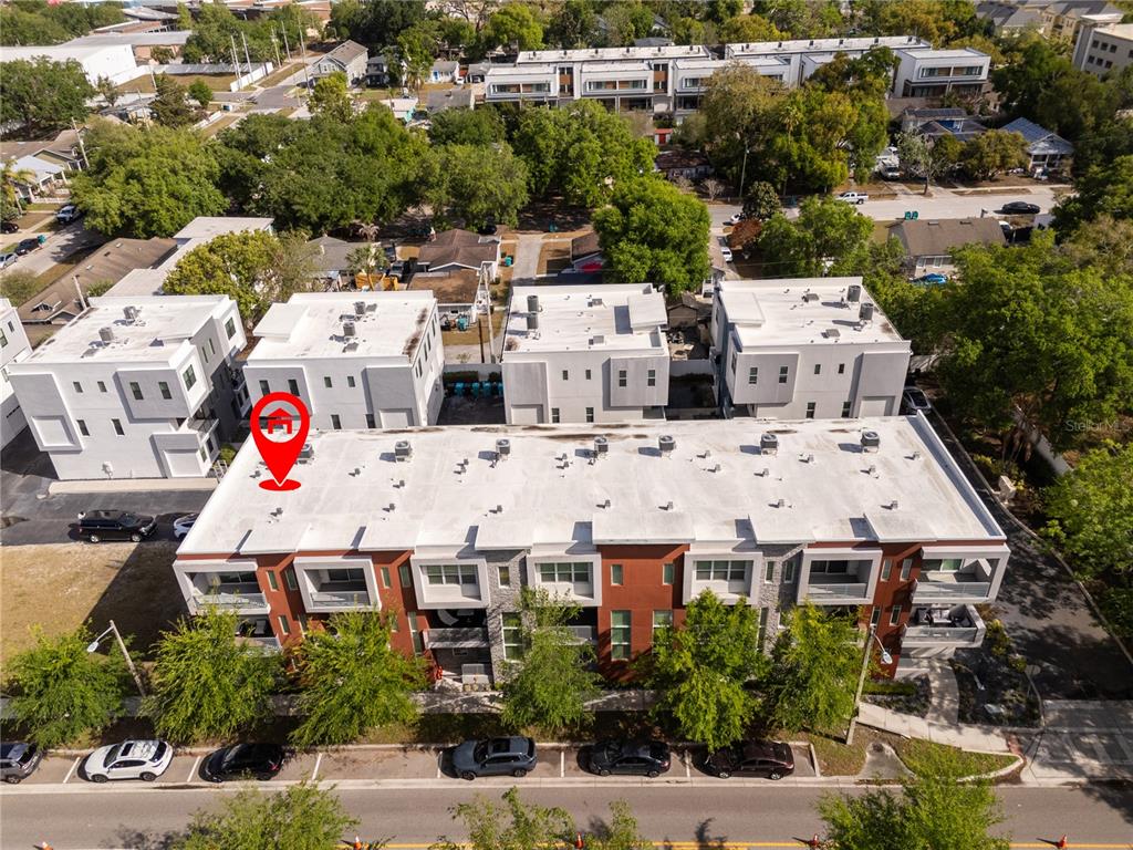An aerial view shows a modern multi-story townhouse complex with flat roofs and balconies — 73 W GRANT STREET, ORLANDO, FL