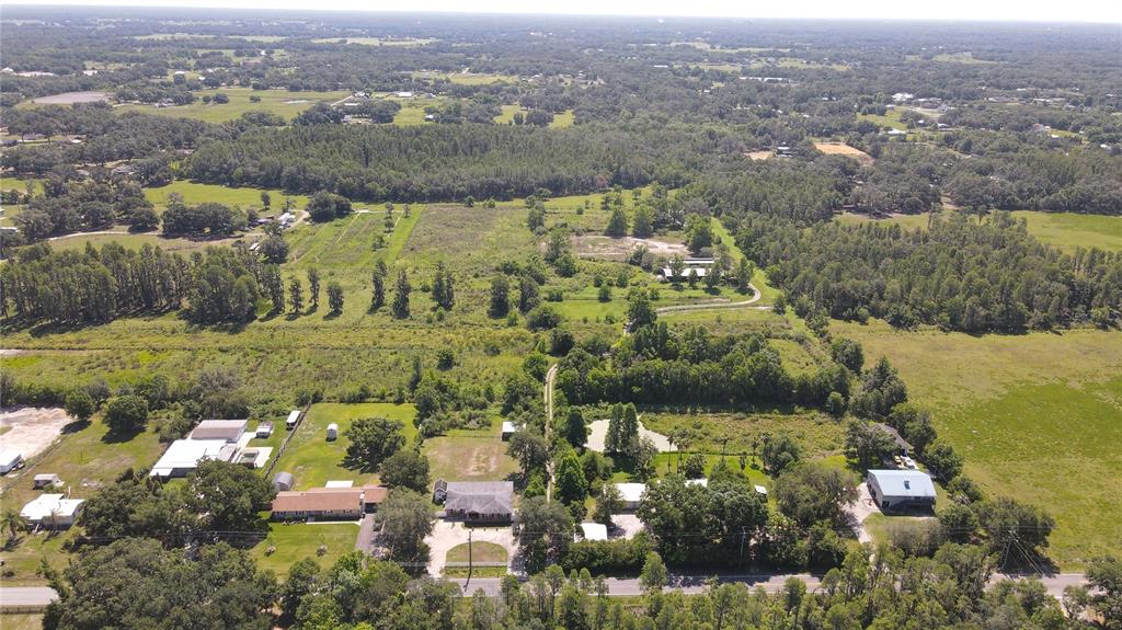 An aerial view shows a rural property with multiple houses, outbuildings, and a pond — 4108 COOPER ROAD, PLANT CITY, FL