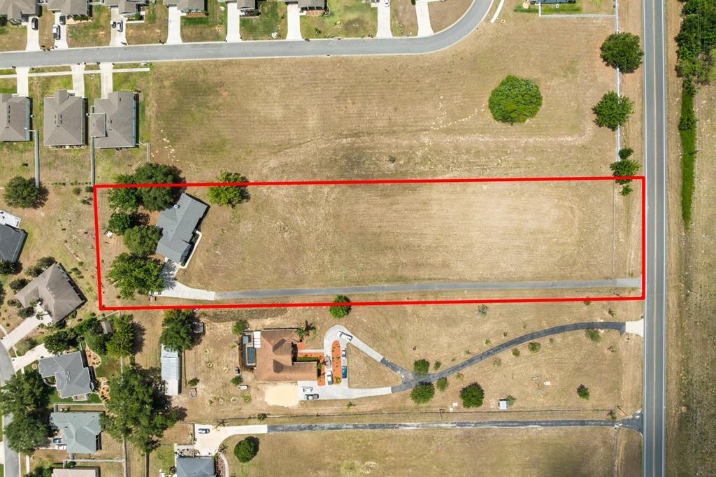 An aerial view shows a rectangular lot containing a house and a long driveway — 37153 COUNTY ROAD 452, GRAND ISLAND, FL
