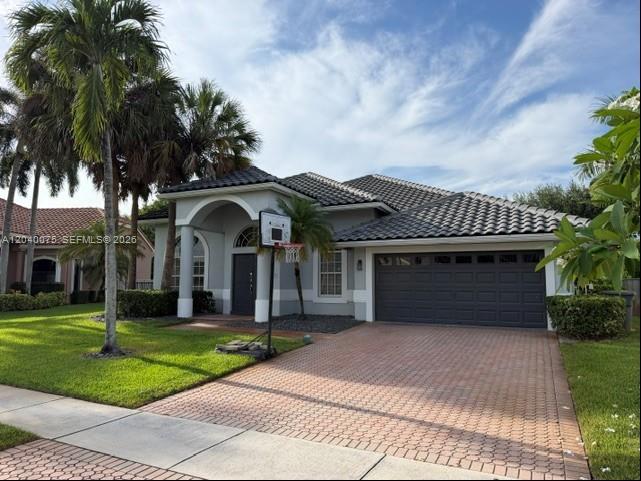 A single-story house with a tiled roof, a paved driveway, and palm trees in the front yard — 19700 Dinner Key Dr, Boca Raton FL 33498, BOCA RATON, FL