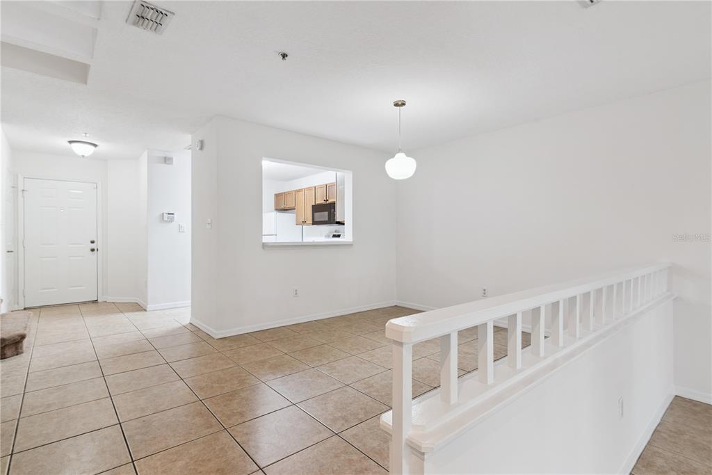 An interior view shows a tiled dining area with a kitchen pass-through window — 685 SCARLET OAK CIRCLE UNIT 109, ALTAMONTE SPRINGS, FL