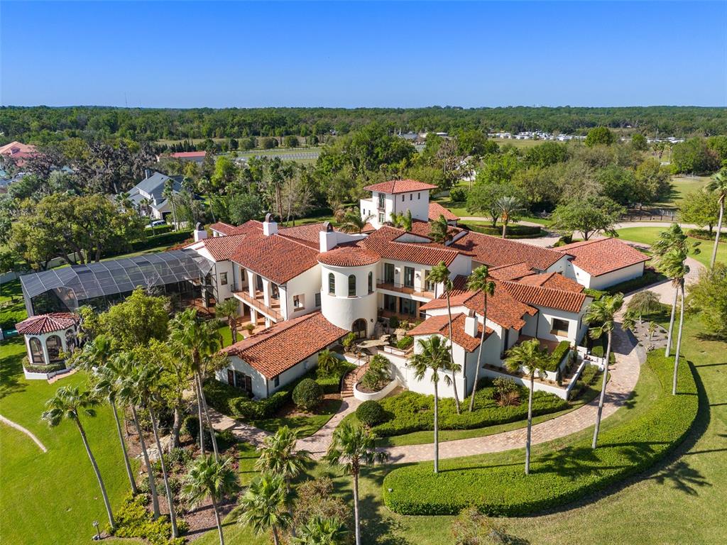 An aerial view of a large Mediterranean-style estate with a red tile roof and pool — 11865 FORT KING HIGHWAY, THONOTOSASSA, FL