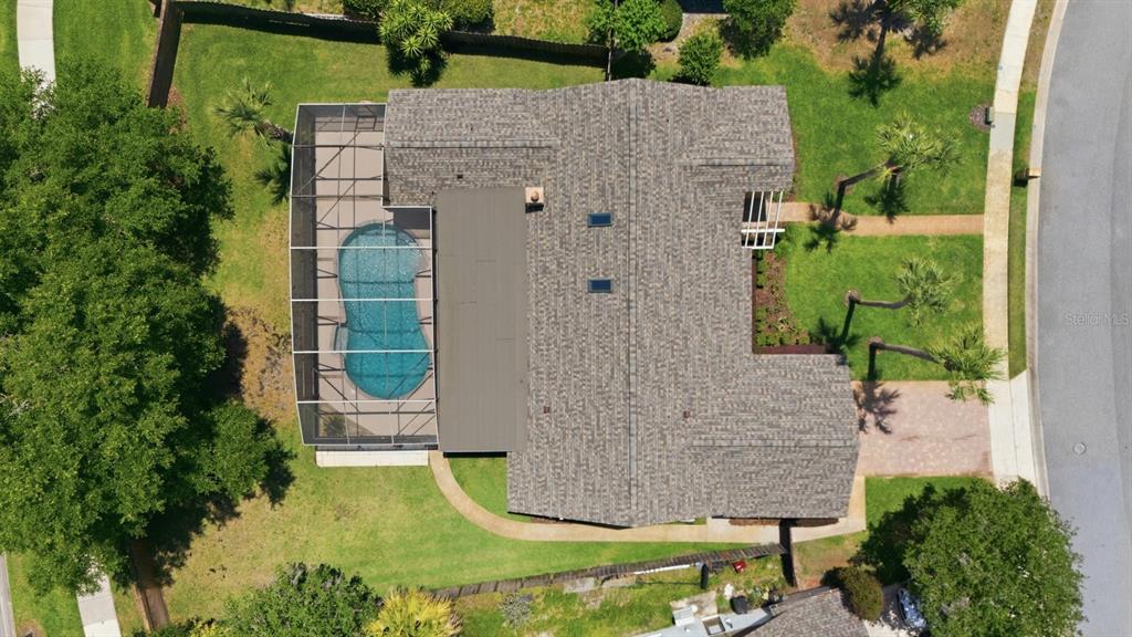 An aerial view shows a house with a screened-in pool and a shingled roof — 478 SABAL TRAIL CIRCLE, LONGWOOD, FL