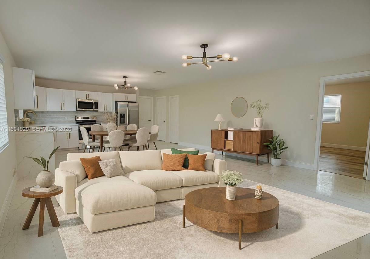 This is a living and dining room with a white sofa, coffee table, and tile flooring — 4340 SW 19th St, West Park FL 33023, WEST PARK, FL