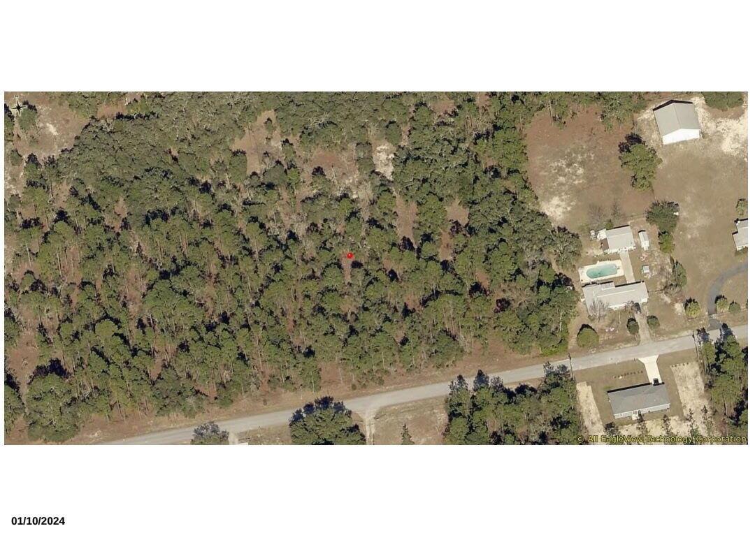 This aerial map view shows a wooded lot adjacent to a residential property with a pool — 0000 SW Nautilus, FL 34431, FL