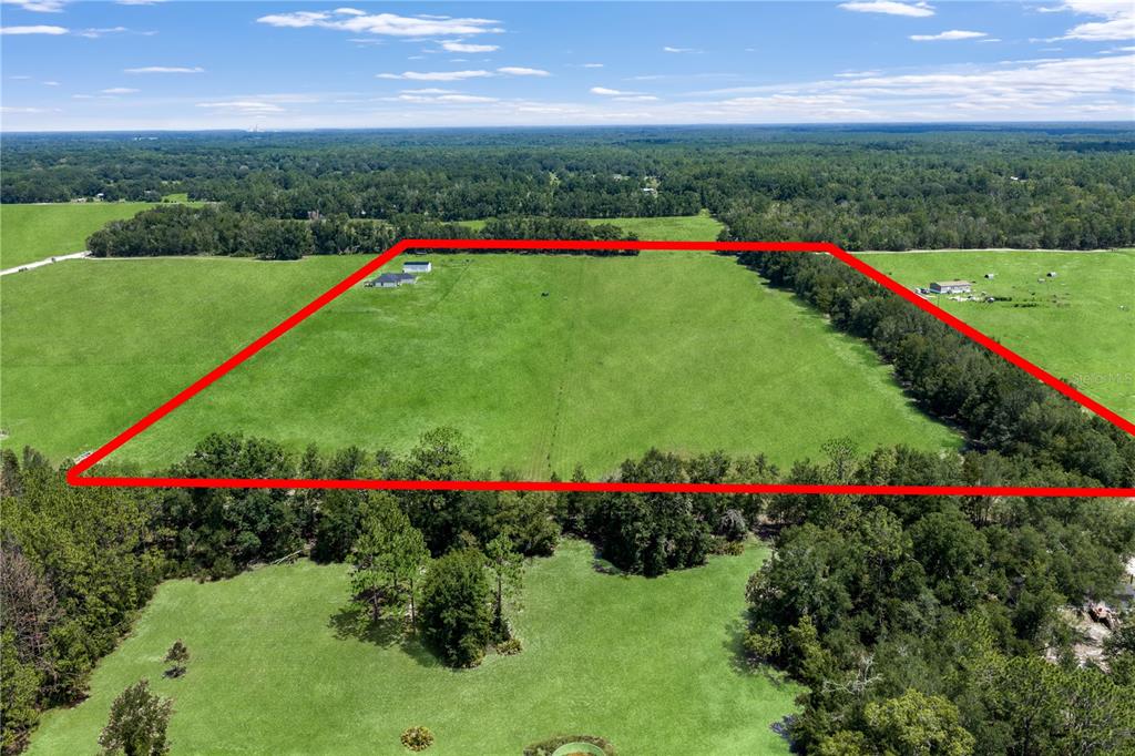 An aerial view shows a large, rectangular grassy field outlined in red with a house — 10240 NW 7TH TERRACE, BRANFORD, FL