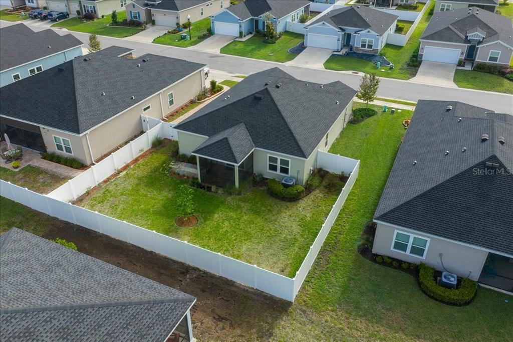 An aerial view shows a suburban house with a fenced backyard and a screened porch — 7542 SW 76TH TERRACE, OCALA, FL