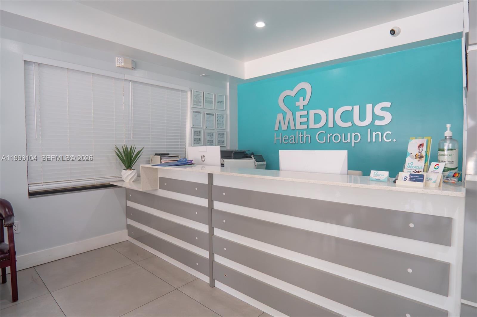 A reception area features a long white and gray desk against a teal logo wall — 2268 SW 8th St, Miami FL 33135, MIAMI, FL