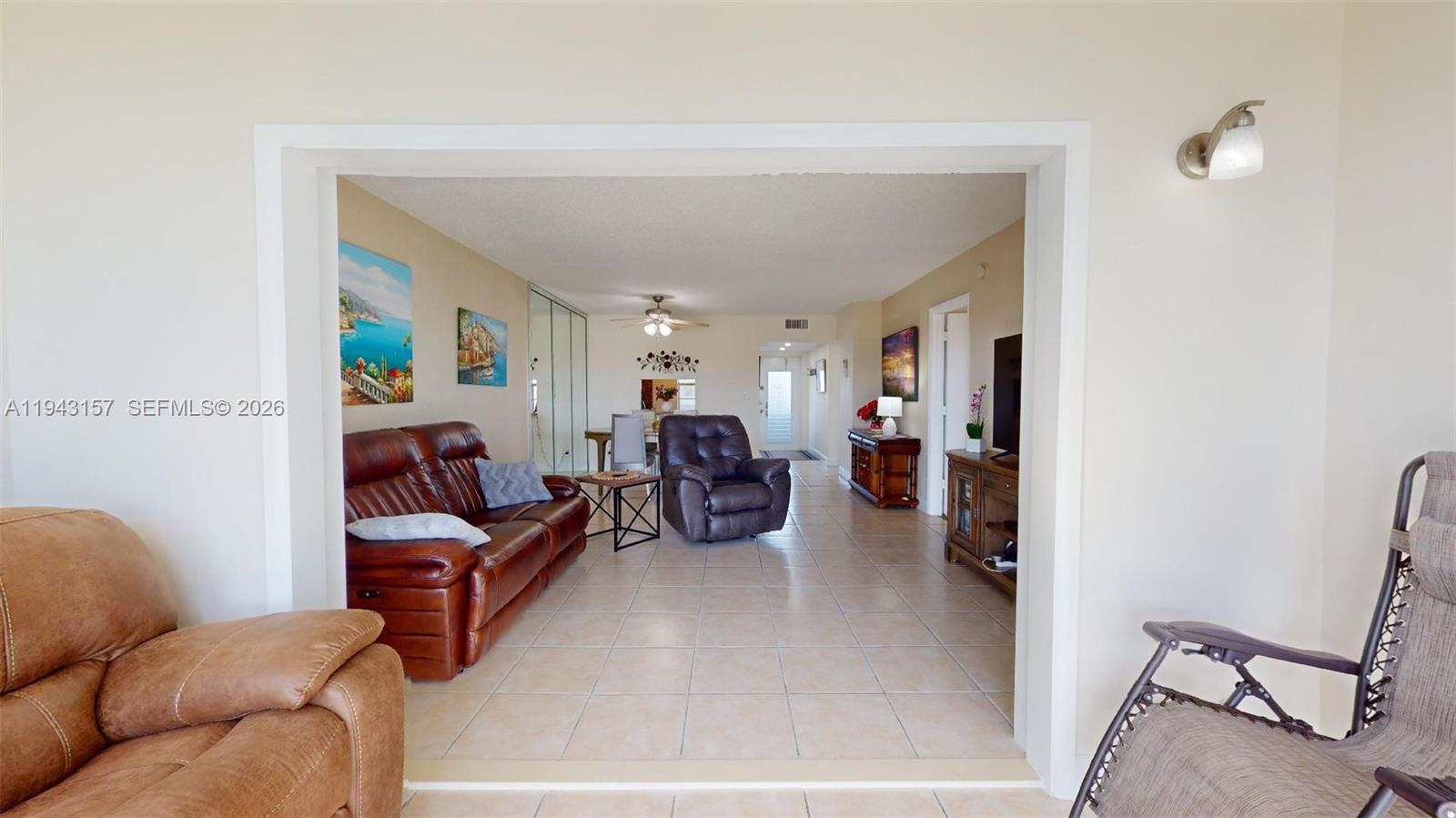 A living room features tile flooring, a leather sofa, a recliner, and a dining area — 7877 Golf Cir Dr # 304, Margate FL 33063, MARGATE, FL