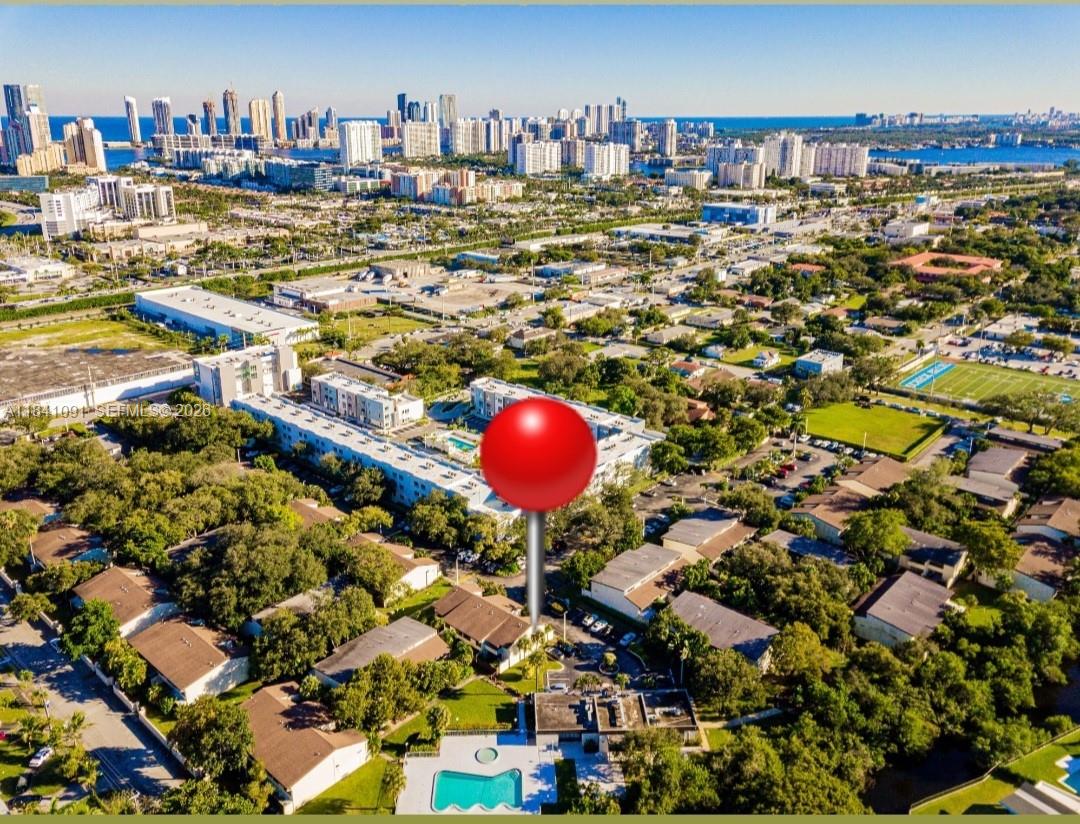 An aerial view shows a residential complex with a pool and a red location pin — 19200 NE 25th Ave # 323C, Miami FL 33180, MIAMI, FL