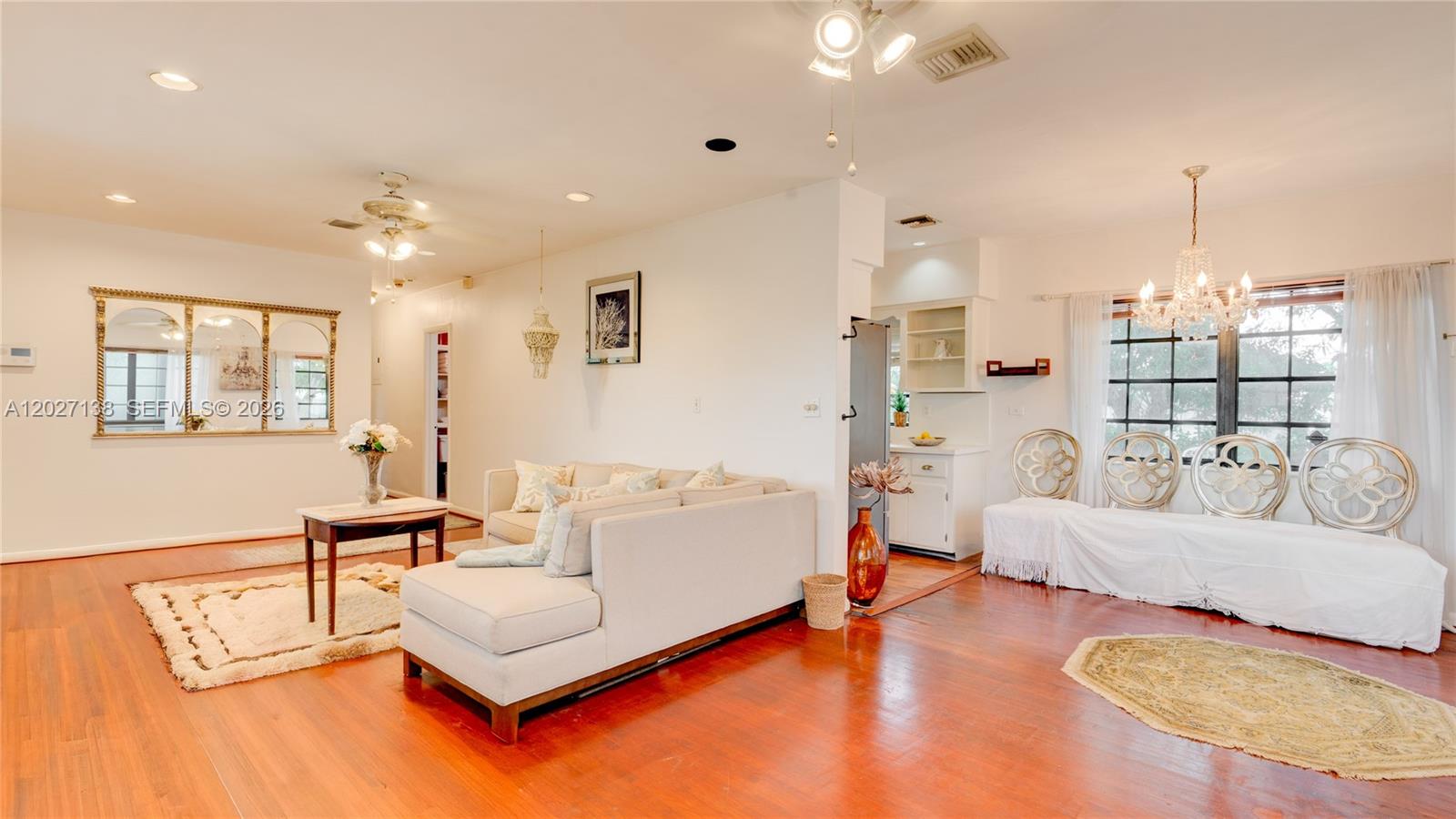 A living room features hardwood floors, a sectional sofa, and a dining area with chandeliers — 10420 SW 149th St, Miami FL 33176, MIAMI, FL
