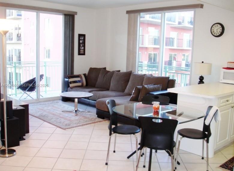 A living room and dining area feature tile floors, a sectional sofa, and balcony access — 3500 Coral Way # 614, Miami FL 33145, MIAMI, FL
