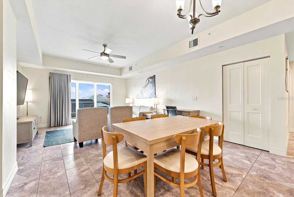 A dining area and office space feature tile flooring, a chandelier, and a ceiling fan — 24 AVALON STREET UNIT 405, CLEARWATER BEACH, FL