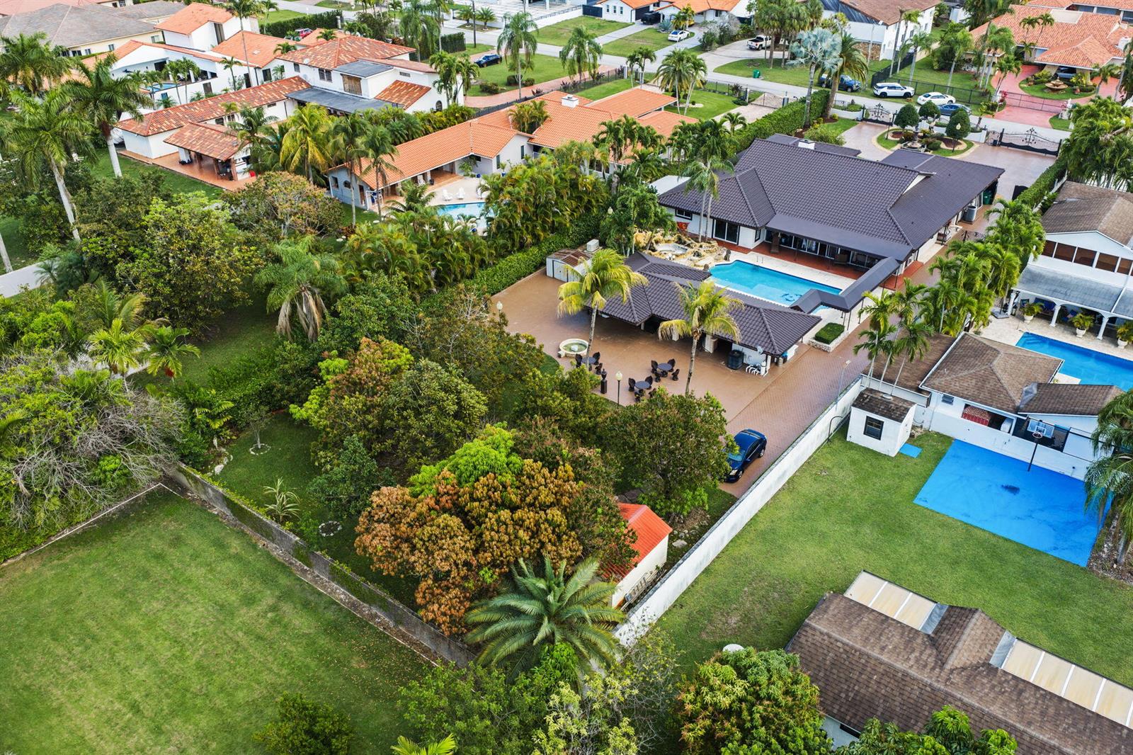 Aerial view of a residential property featuring a large house, pool, and expansive backyard — 2840 SW 128th Avenue, Miami FL 33175, MIAMI, FL