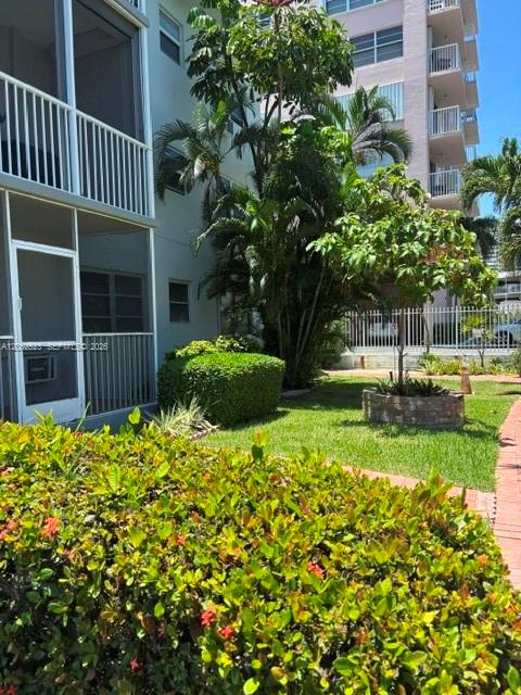 A view of a multi-story apartment building exterior with a green lawn and landscaping — 3177 S Ocean Dr # 217, Hallandale Beach FL 33009, HALLANDALE BEACH, FL