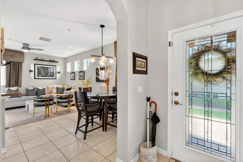 A view from an entryway into a living and dining area with tile flooring — 2125 VELVET LEAF DRIVE, OCOEE, FL