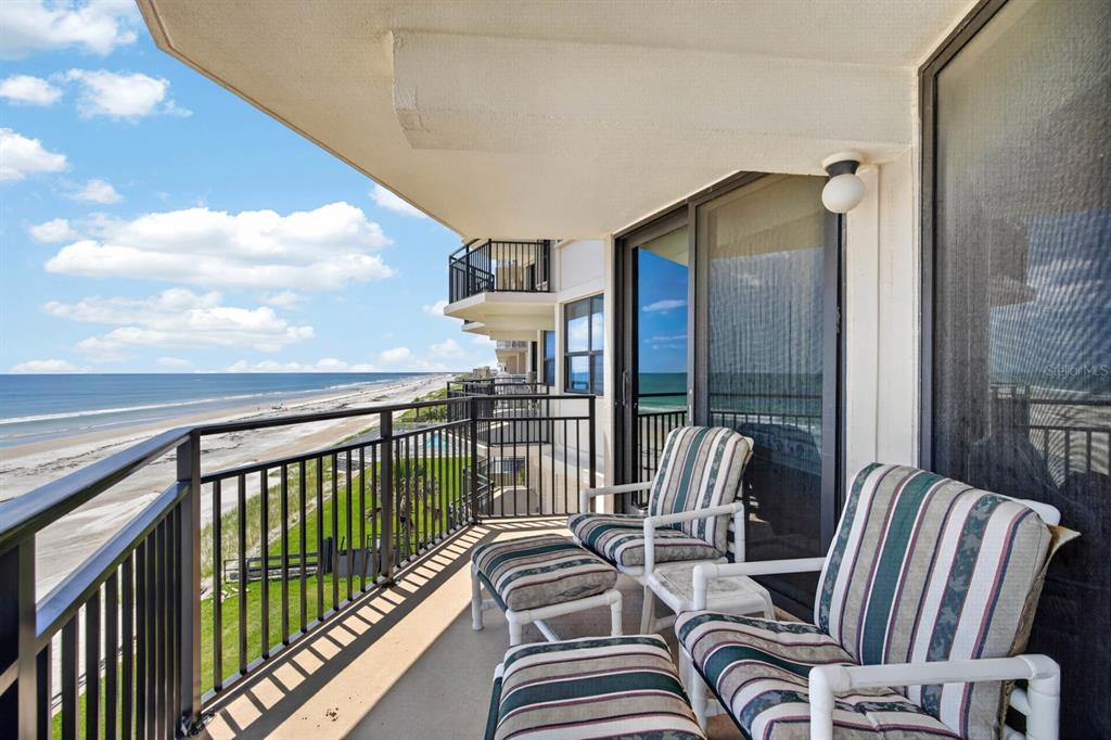 A balcony with patio furniture overlooks a sandy beach and the ocean — 4745 S ATLANTIC AVENUE UNIT 4050, PONCE INLET, FL