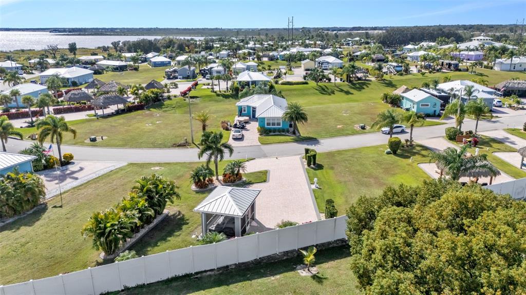 An aerial view shows a residential neighborhood with a blue house and a gazebo — 2947 WOOD DUCK DRIVE, POLK CITY, FL
