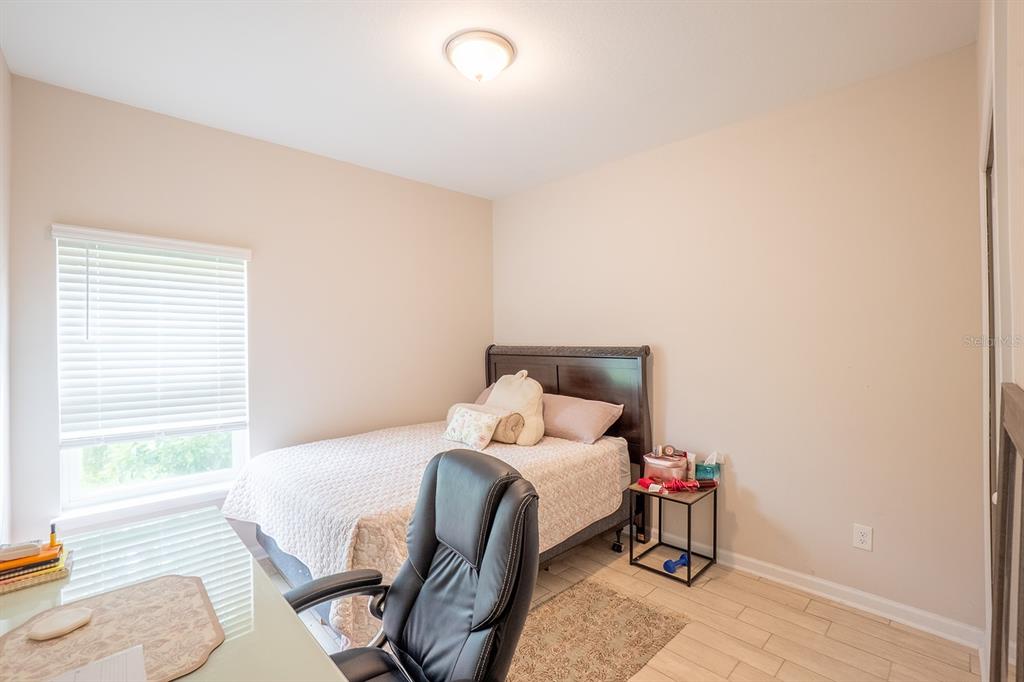 A dining room with a wooden table, light-colored chairs, and a glass display cabinet — 524 GRAND LANDINGS PARKWAY, PALM COAST, FL