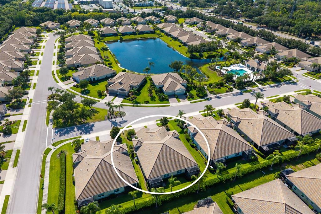 An aerial view shows a residential neighborhood with a central pond and a circled house — 5437 CHATHAM SQUARE WAY, BRADENTON, FL