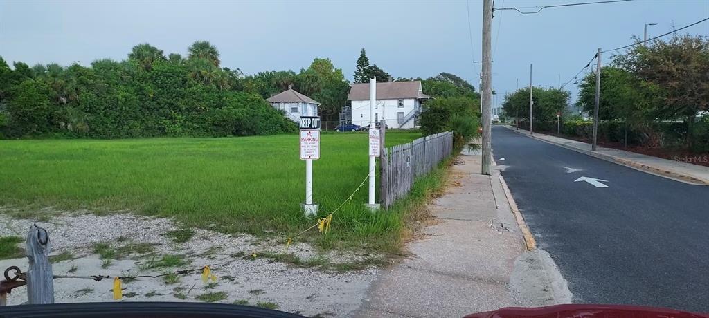 A vacant grassy lot sits next to a sidewalk and a paved road — 11 N HOLLYWOOD AVENUE, DAYTONA BEACH, FL