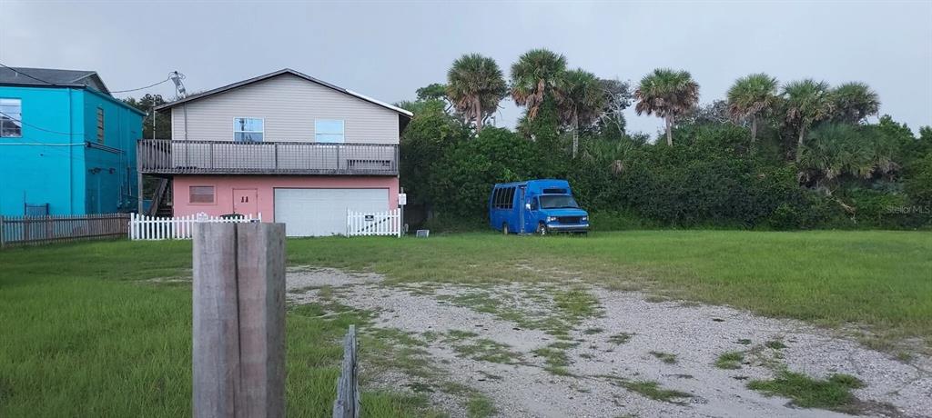 A two-story house with a blue bus parked on the adjacent grassy lot — 11 N HOLLYWOOD AVENUE, DAYTONA BEACH, FL