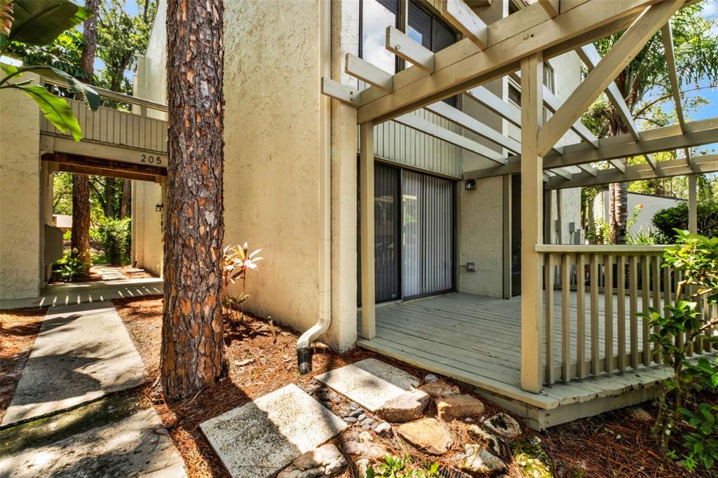A collage showing a townhouse exterior, a living room, a bedroom, and a pond view — 105 FAIRWAY DRIVE, LONGWOOD, FL