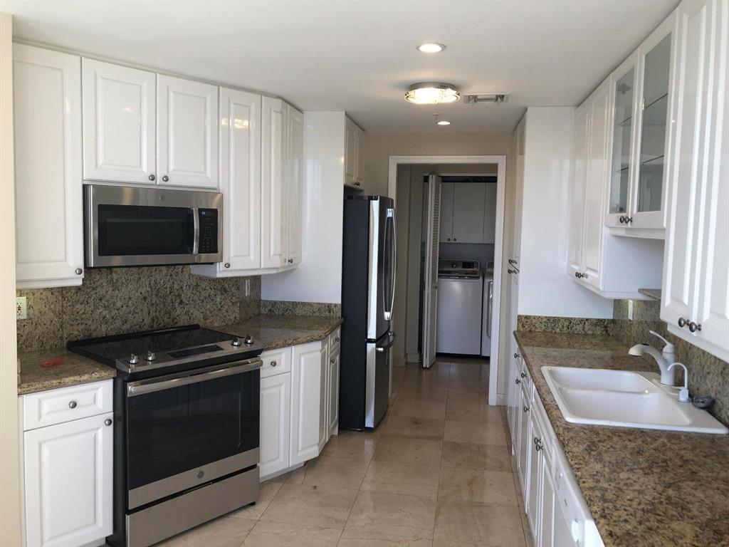 A kitchen with white cabinets, granite countertops, stainless steel appliances, and tile flooring — 848 Brickell Key Drive # 1505, Miami FL 33131, MIAMI, FL