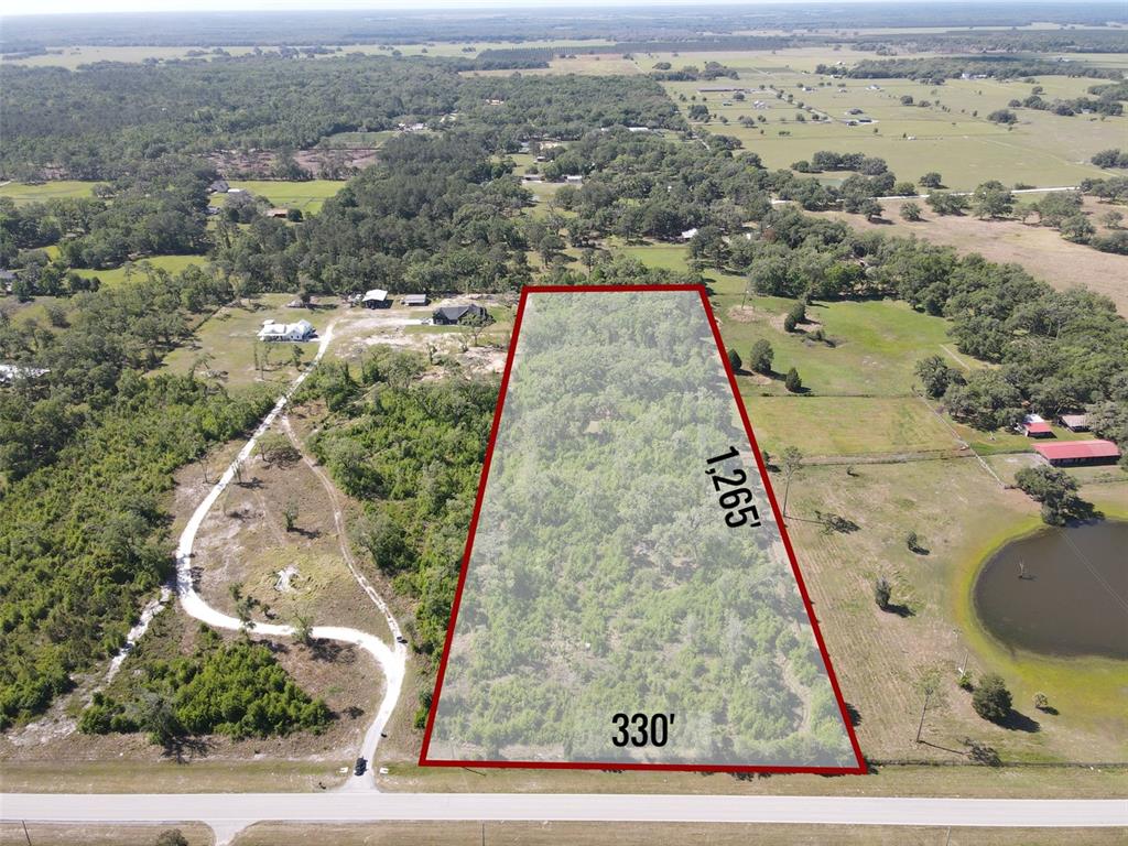 An aerial view shows a rectangular plot of land highlighted in red with dimensions — AYERS ROAD, BROOKSVILLE, FL