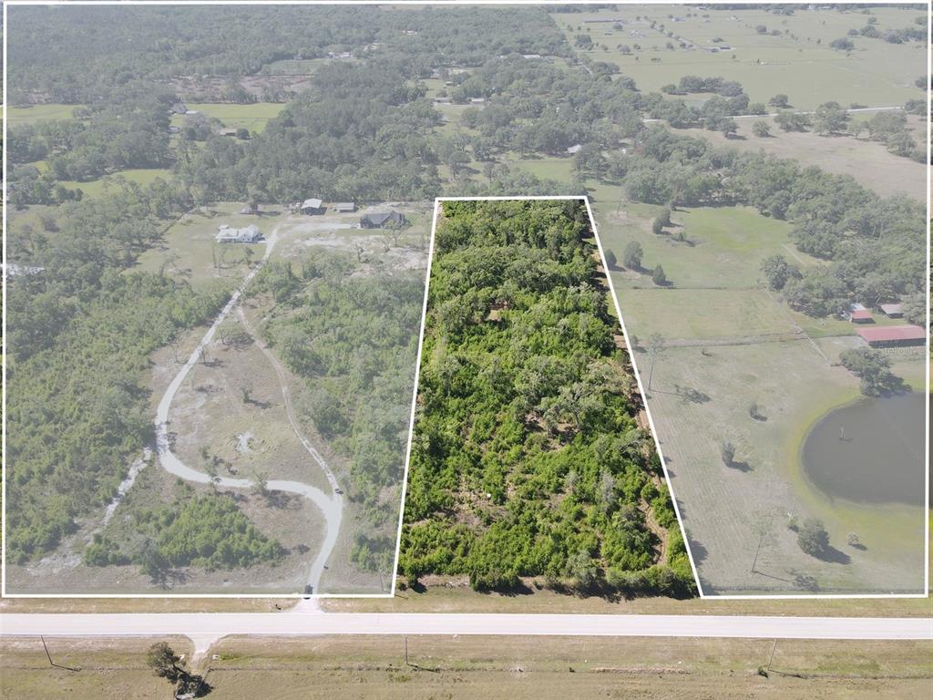 An aerial view shows a rectangular, tree-covered lot outlined in white along a paved road — AYERS ROAD, BROOKSVILLE, FL