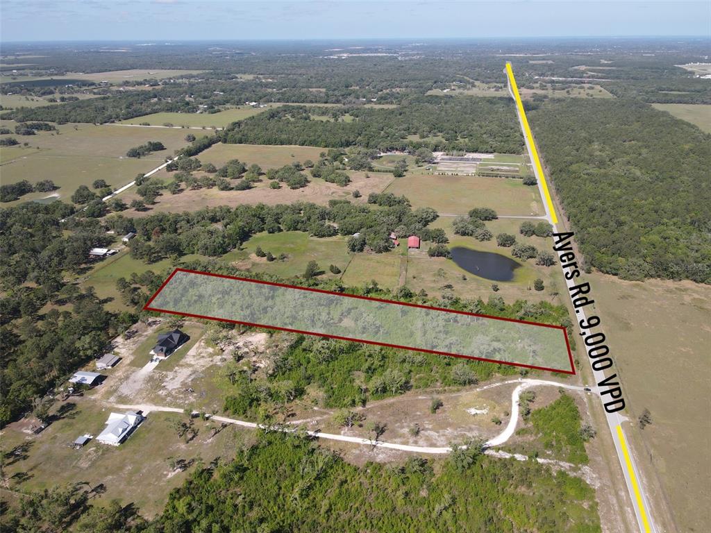 An aerial view shows a rectangular plot of land outlined in red next to a road — AYERS ROAD, BROOKSVILLE, FL