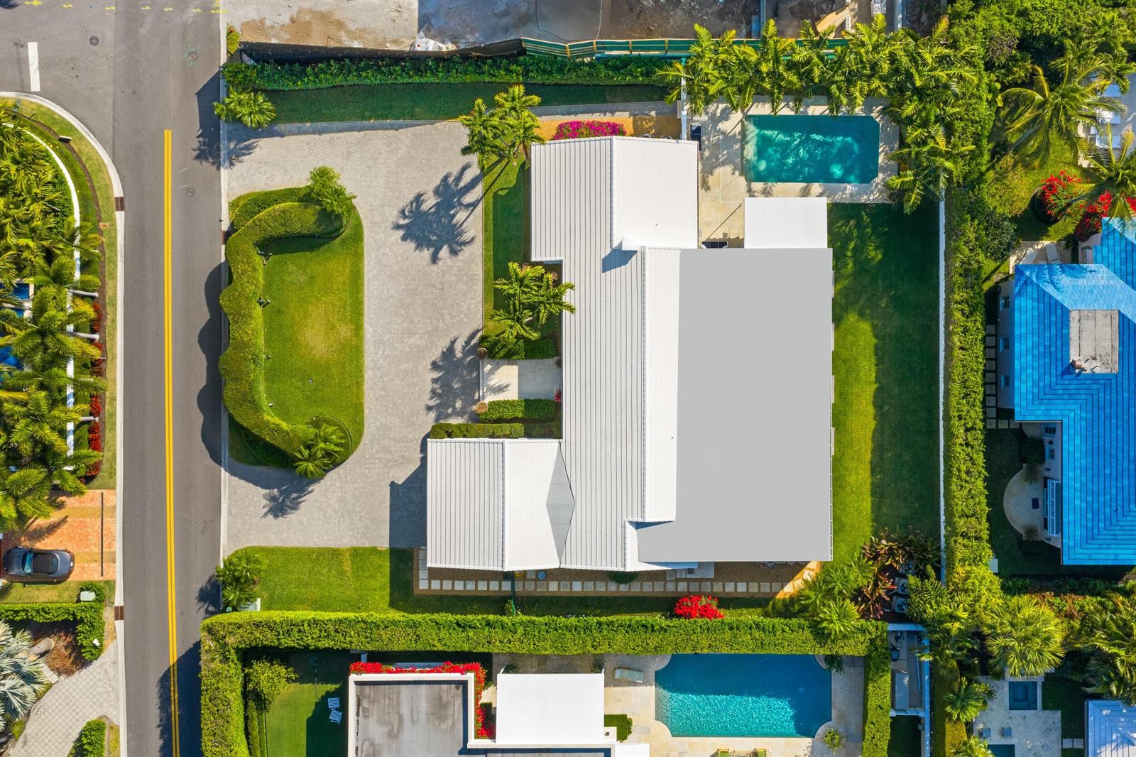 An aerial view of a residential property featuring a white-roofed house, pool, and landscaped yard — 624 N Lake Way, Palm Beach FL 33480, PALM BEACH, FL
