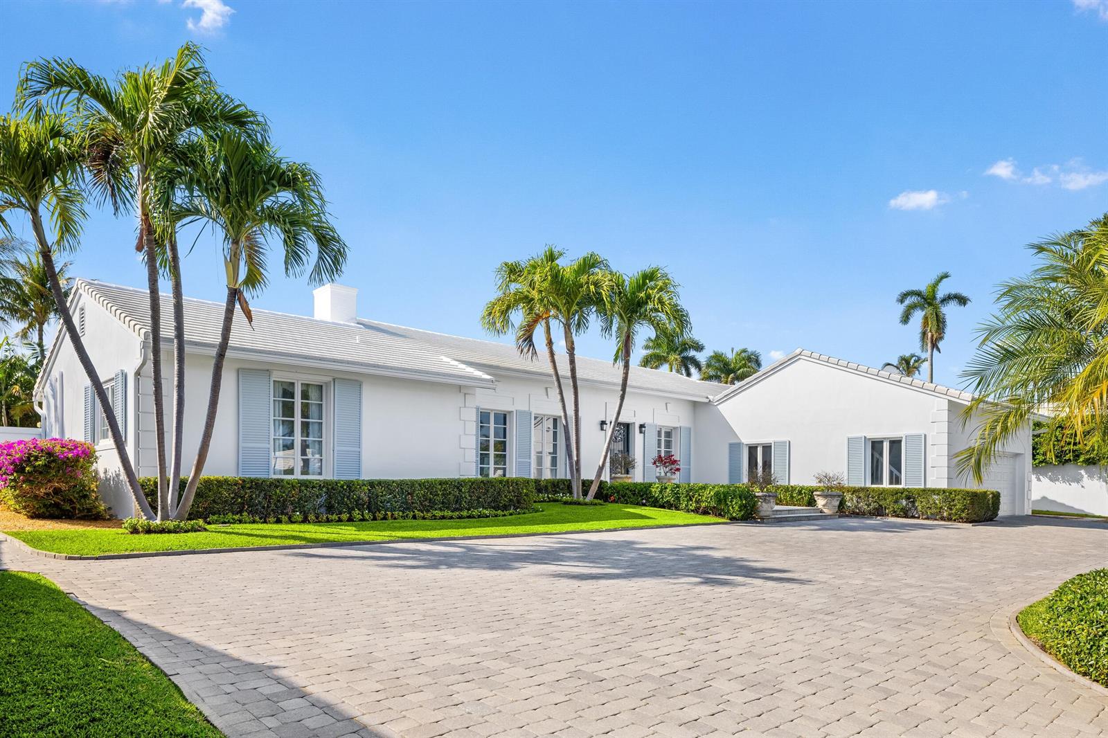 A white single-story house with blue shutters, palm trees, and a paved driveway — 624 N Lake Way, Palm Beach FL 33480, PALM BEACH, FL