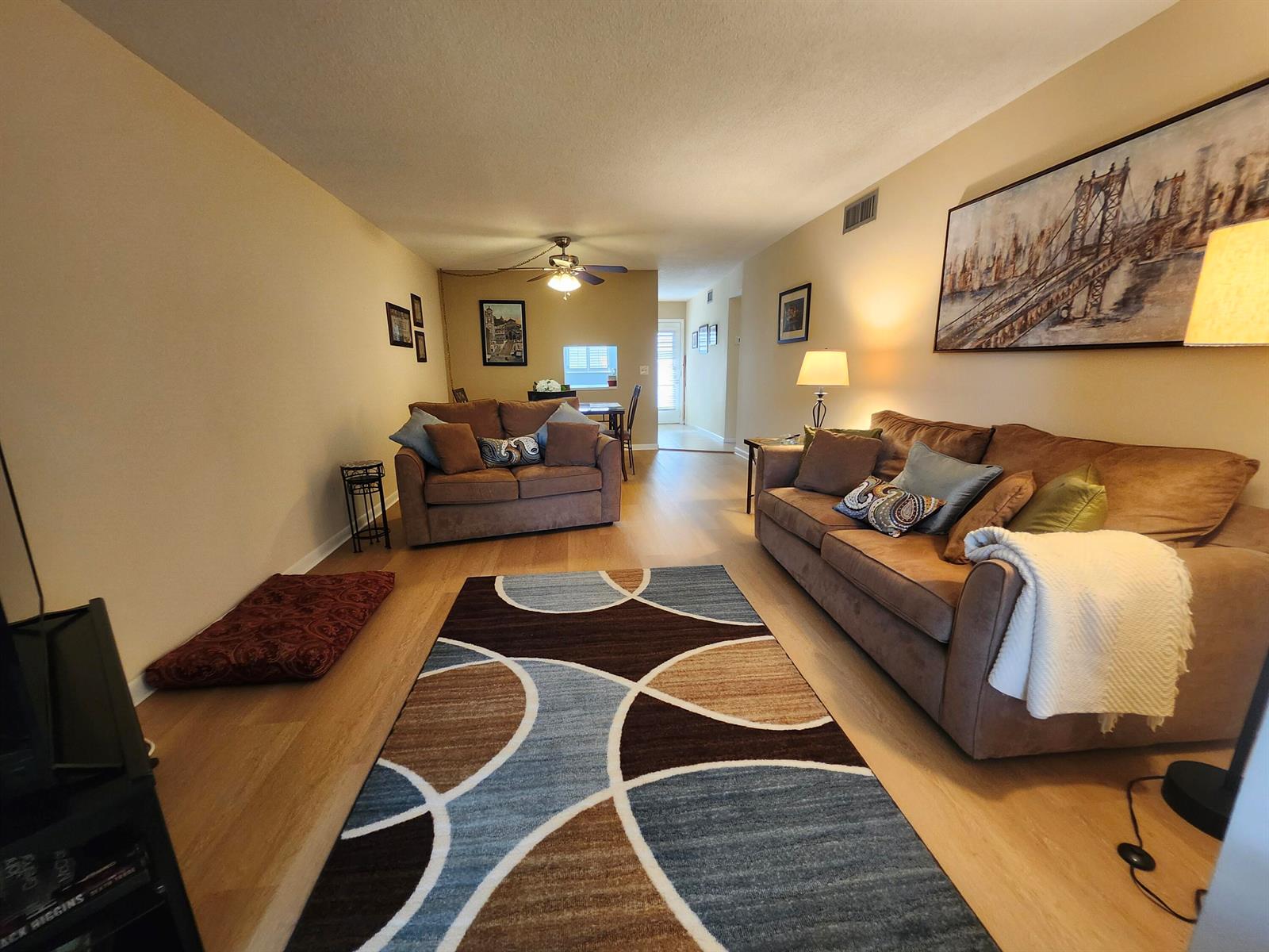 A living room features two brown sofas, a patterned area rug, and light wood flooring — 2600 NE 1st Lane # 311, Boynton Beach FL 33435, BOYNTON BEACH, FL