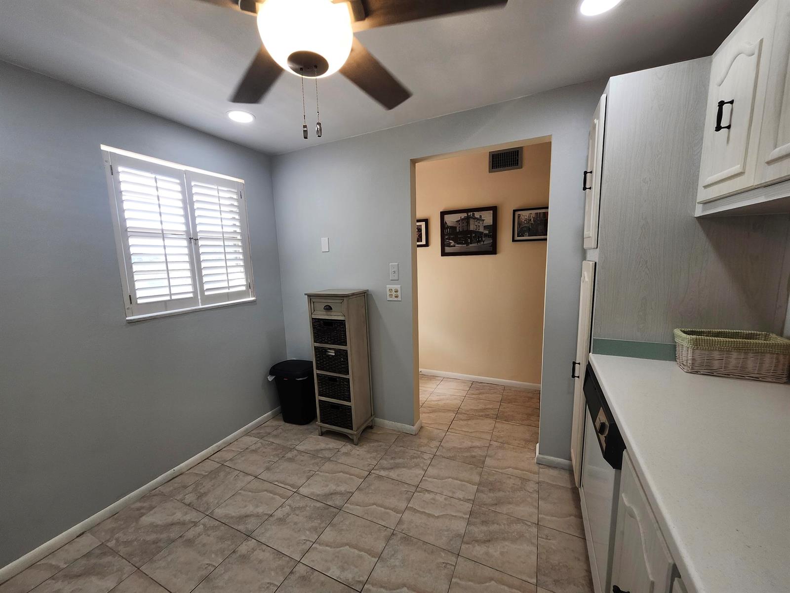 A kitchen area features light gray walls, tile flooring, a ceiling fan, and white cabinetry — 2600 NE 1st Lane # 311, Boynton Beach FL 33435, BOYNTON BEACH, FL