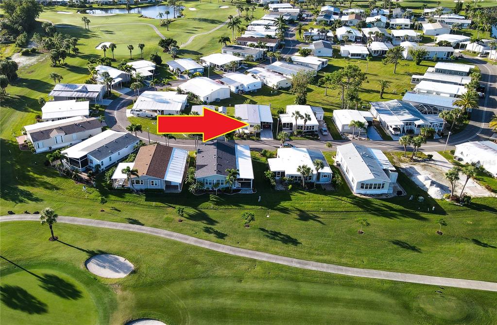 An aerial view of a residential neighborhood featuring manufactured homes situated along a golf course — 2100 KINGS HIGHWAY UNIT 840, PORT CHARLOTTE, FL