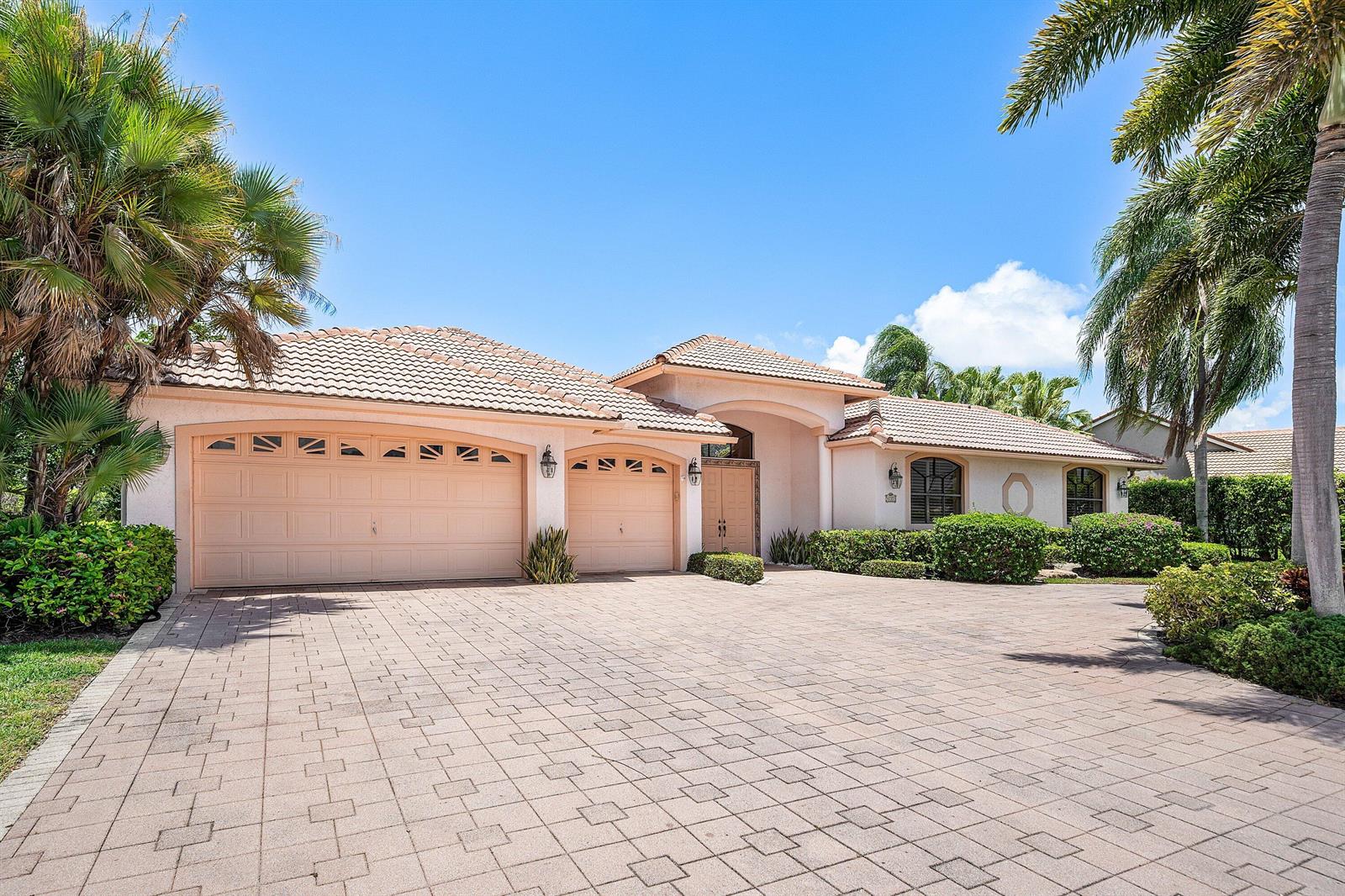 A single-story house with a tiled roof, three-car garage, and a paved driveway — 4727 Bocaire Boulevard, Boca Raton FL 33487, BOCA RATON, FL