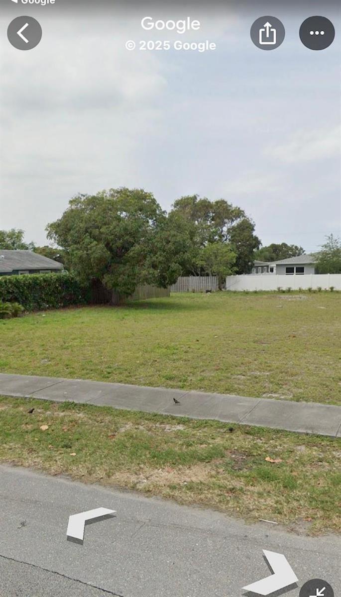 A vacant, grassy residential lot features a large tree and a sidewalk in the foreground — 132 & 134 NW 6th Avenue, Delray Beach FL 33444, DELRAY BEACH, FL