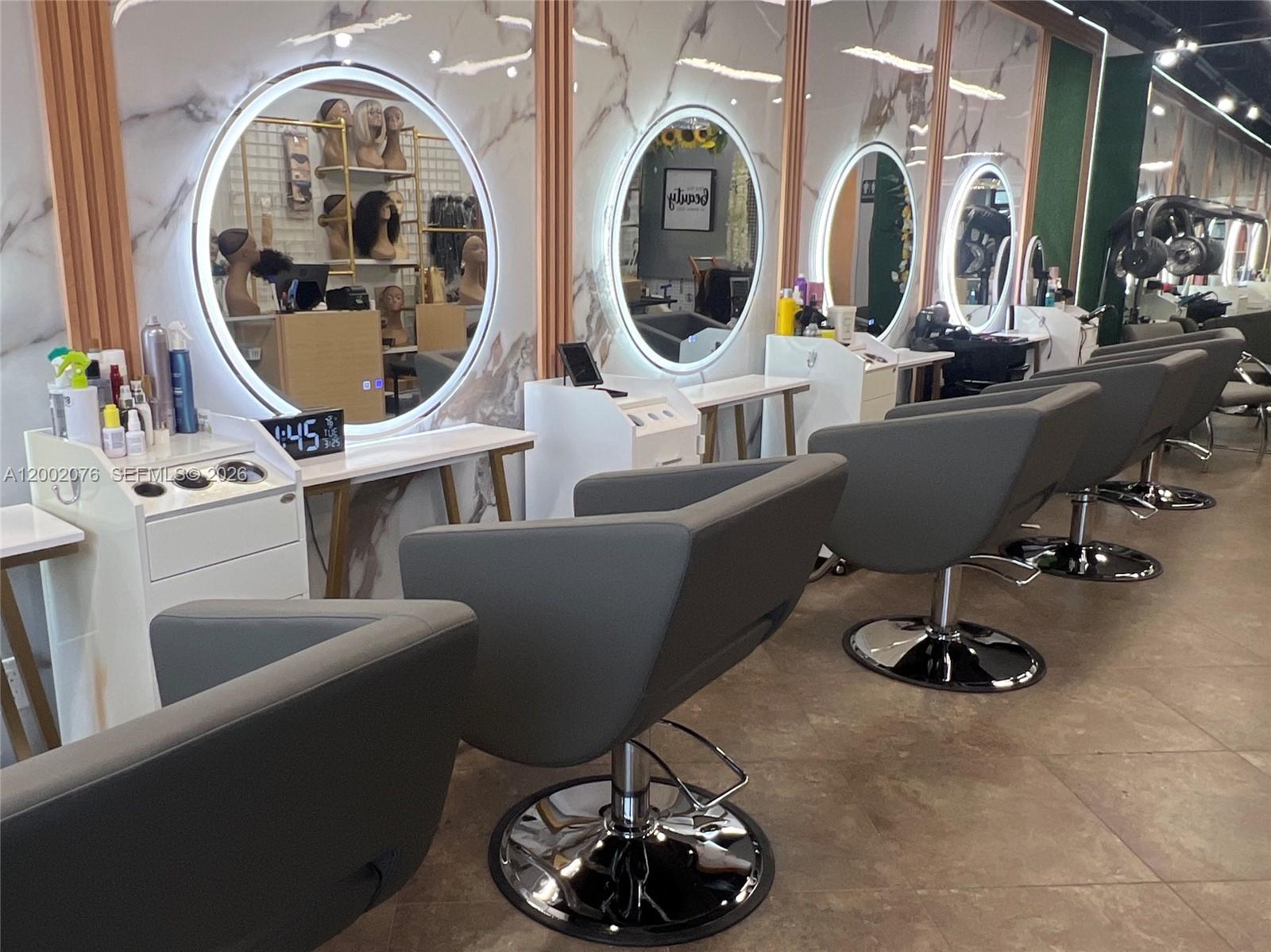 A hair salon features multiple styling stations with circular LED mirrors and gray swivel chairs — 1576 NE 205th ter, Miami FL 33179, MIAMI, FL