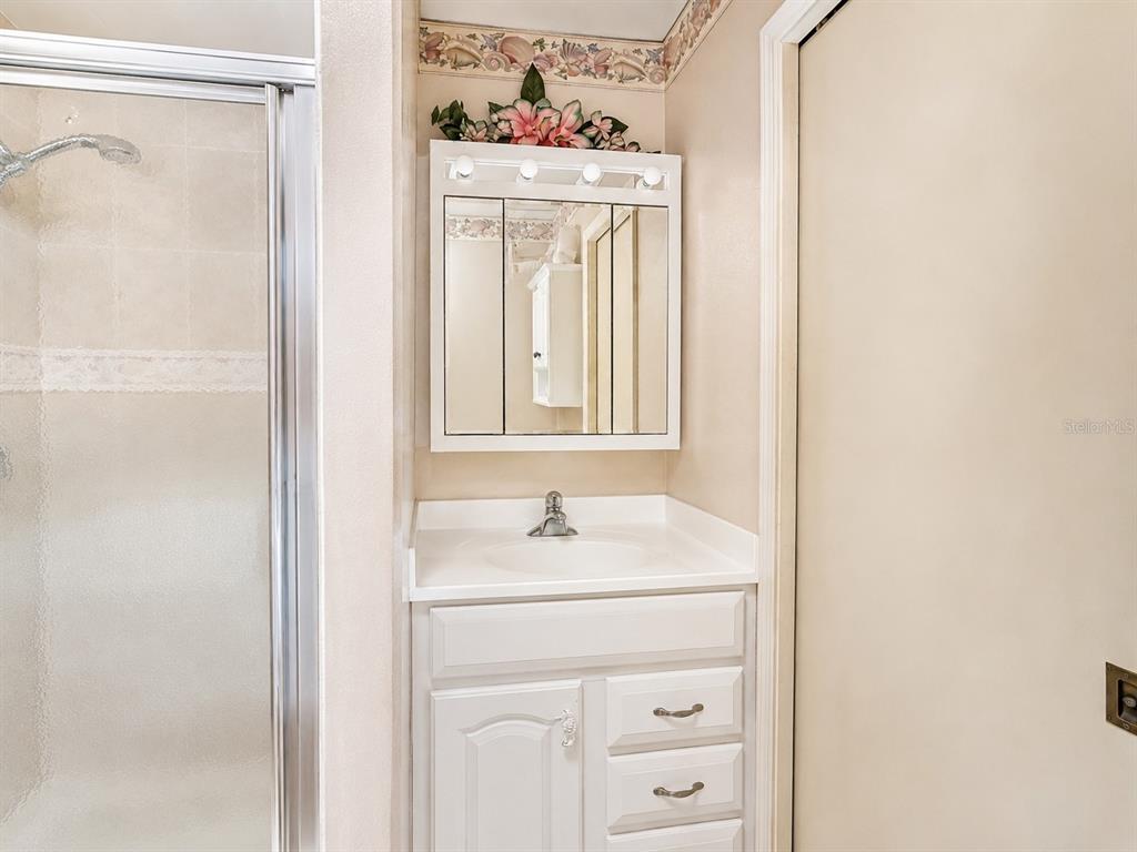A laundry room features two gray Maytag appliances, white cabinets, and a utility sink — 3488 DWIGHT STREET, PORT CHARLOTTE, FL