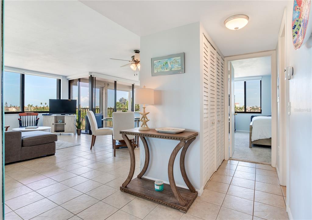 A tiled entryway leads to a living area with a balcony and a bedroom doorway — 6104 PALMA DEL MAR BOULEVARD S UNIT 404, ST PETERSBURG, FL