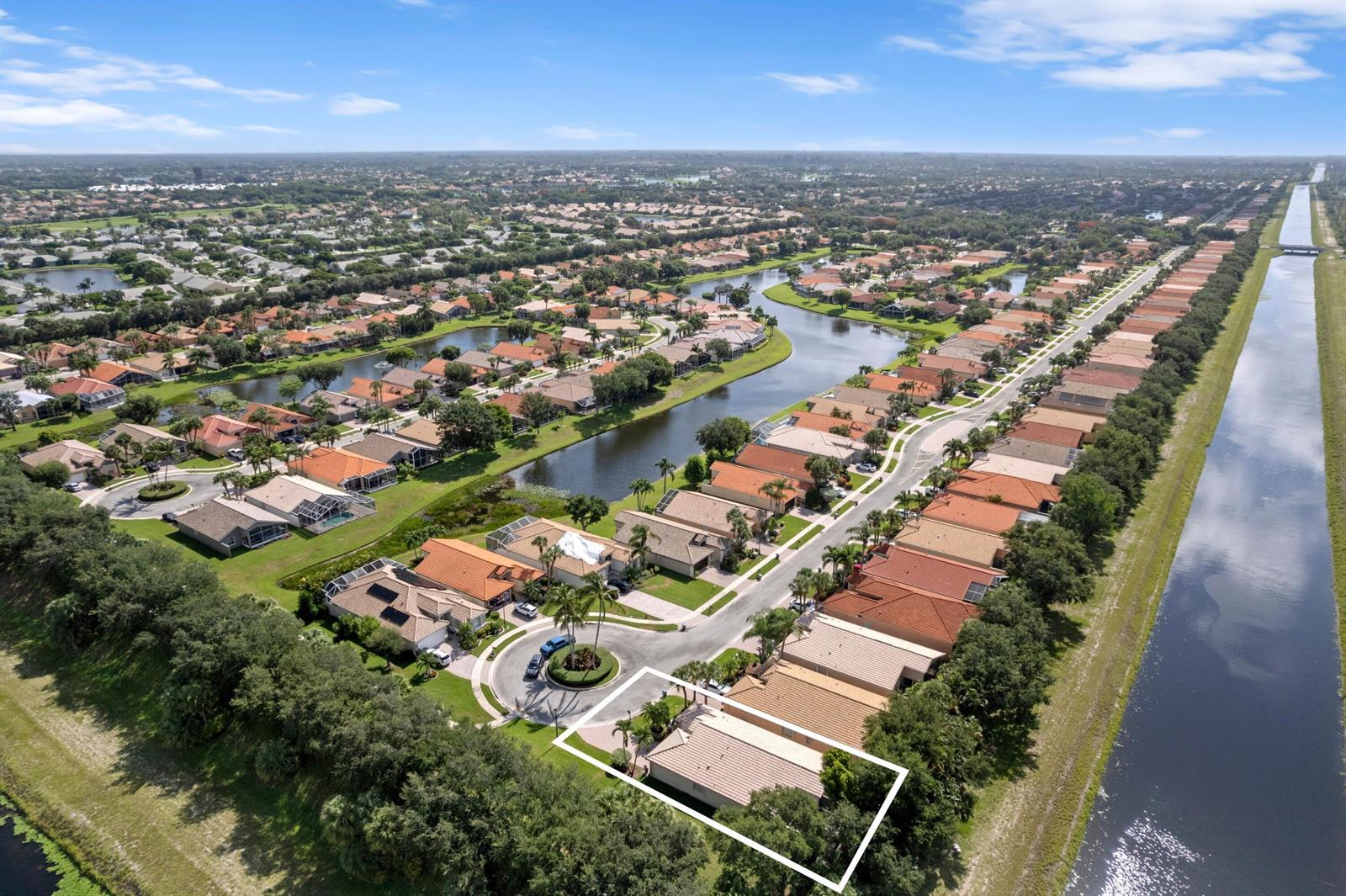 An aerial view shows a residential neighborhood with a highlighted house near a canal — 7818 Caprio Drive, Boynton Beach FL 33472, BOYNTON BEACH, FL